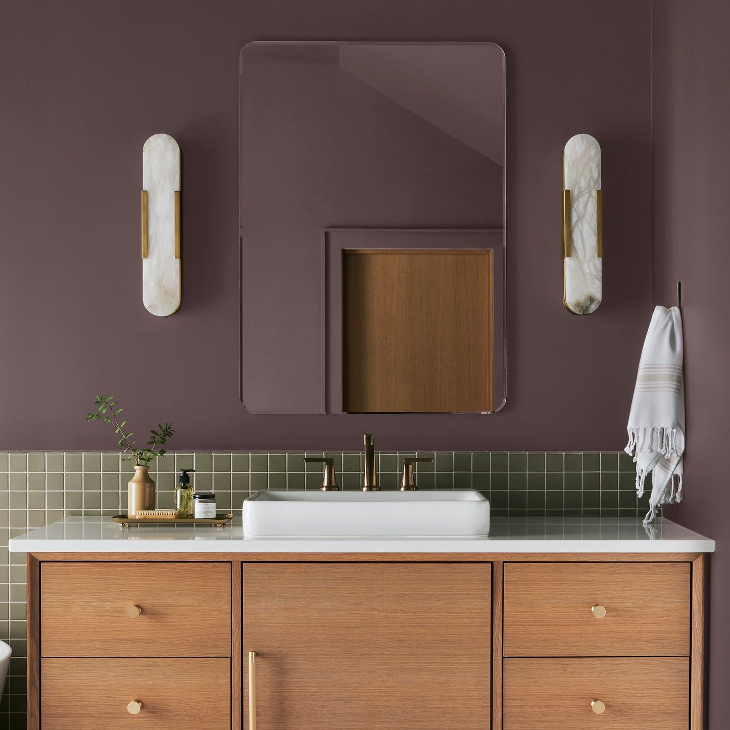 A rich burgundy interior paint named Moody Fig shown painted on bathroom wall