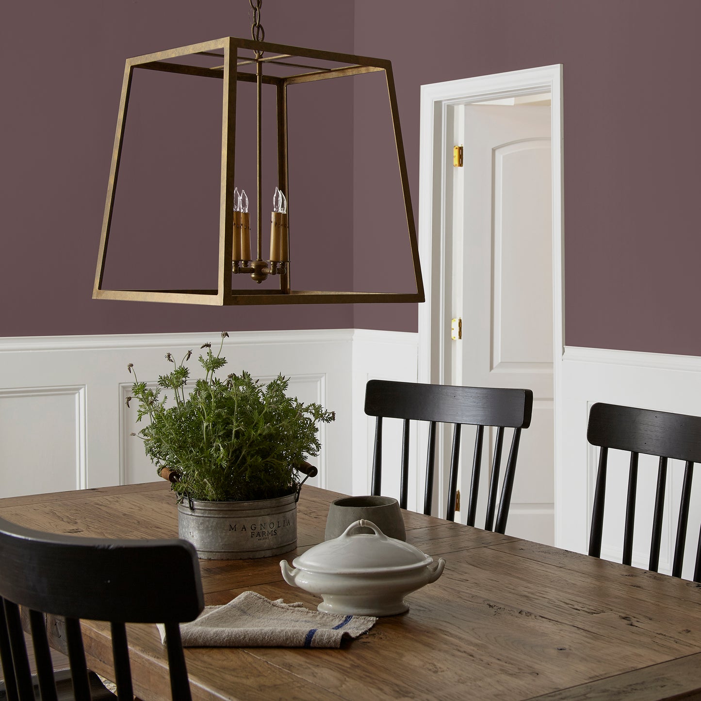 A rich burgundy interior paint named Moody Fig shown painted on dining room wall