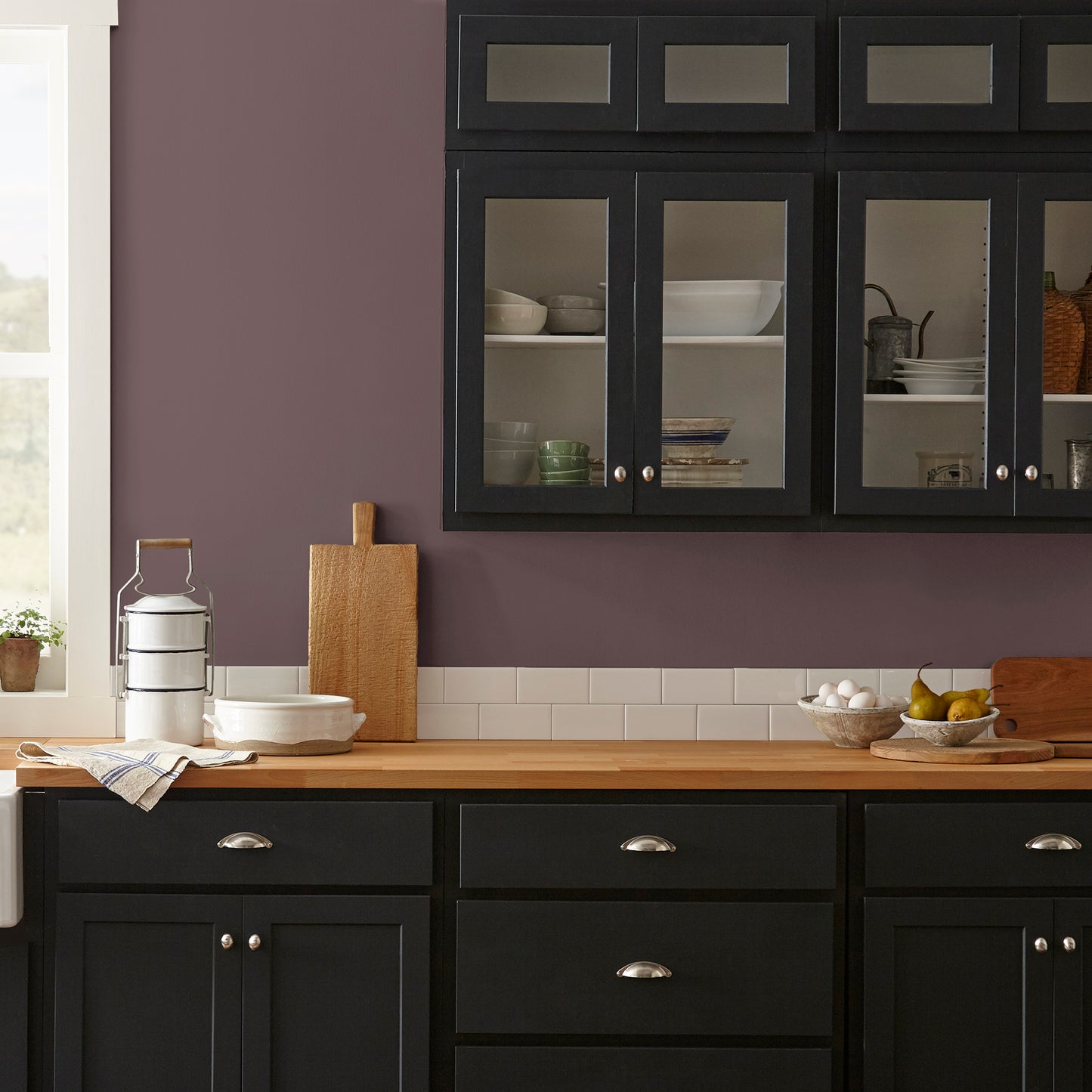 A rich burgundy interior paint named Moody Fig shown painted on kitchen wall