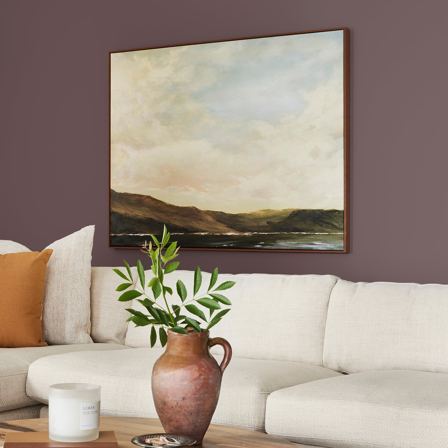 A rich burgundy interior paint named Moody Fig shown painted on living room wall