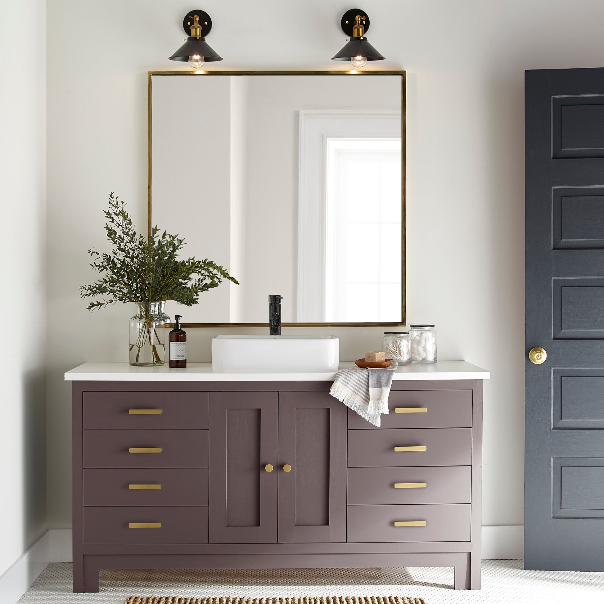 A beautifully saturated burgundy door and cabinet paint named moody fig shown painted on bathroom cabinet