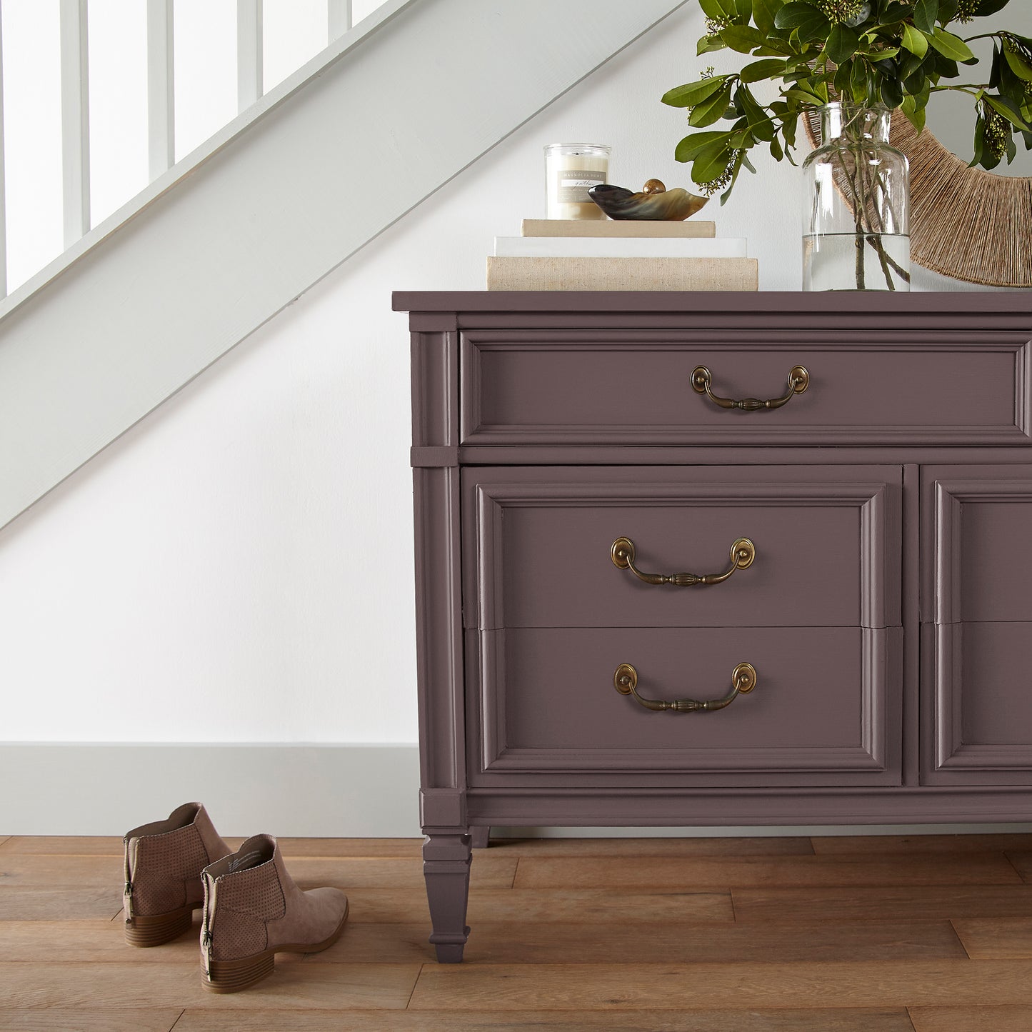 A beautifully saturated burgundy door and cabinet paint named moody fig shown painted on entryway cabinet