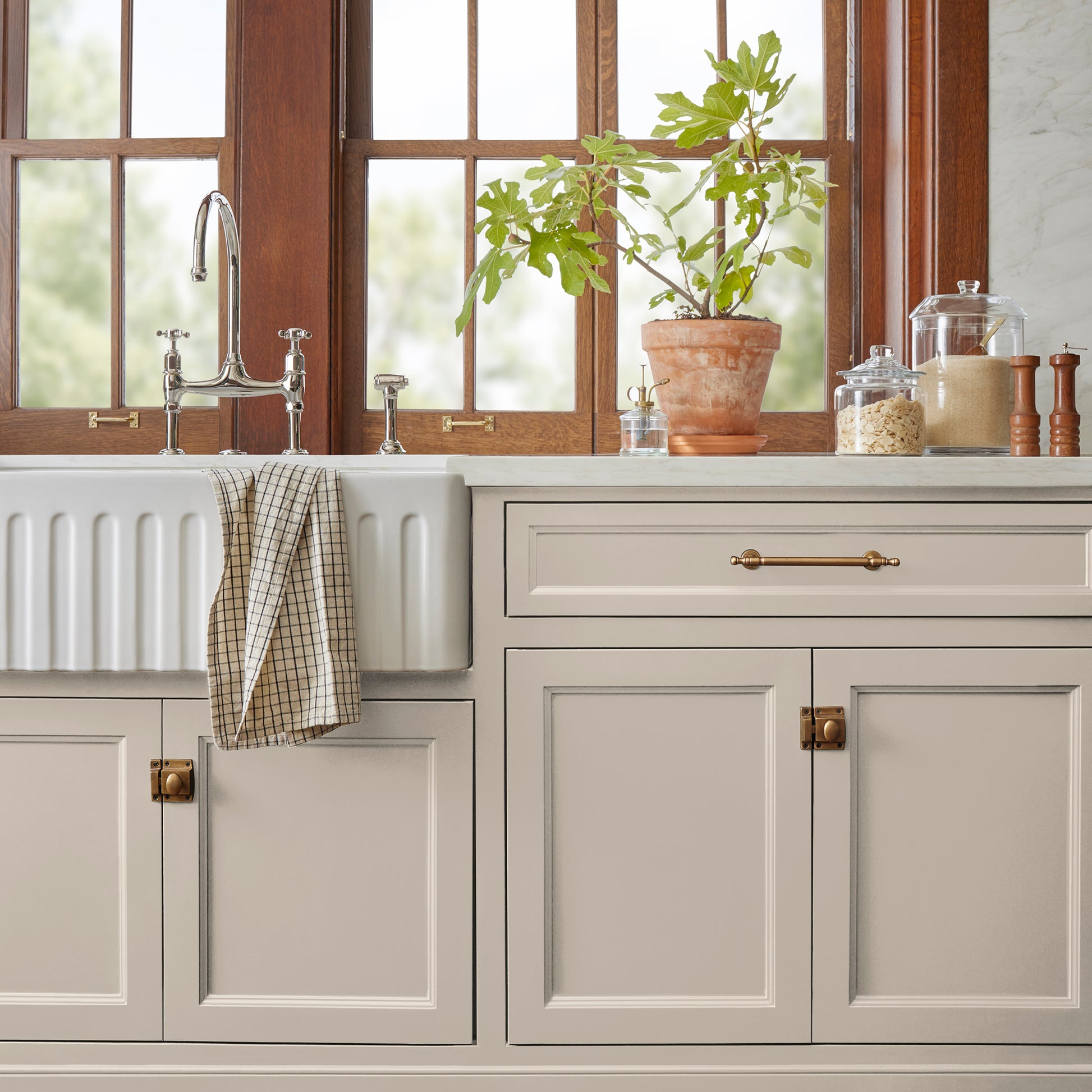 A light beige with a warm, soothing tone door and cabinet paint named plaster shown painted on kitchen cabinet