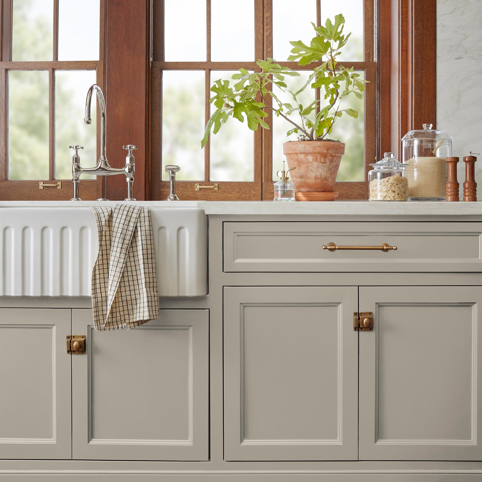 A soft French gray door and cabinet paint named drawing room shown painted on kitchen cabinet