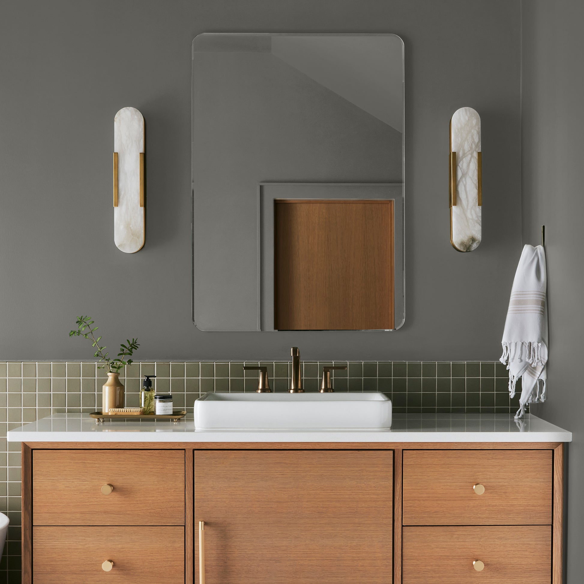 Sage green with gray undertones interior paint named estate shown painted on bathroom wall