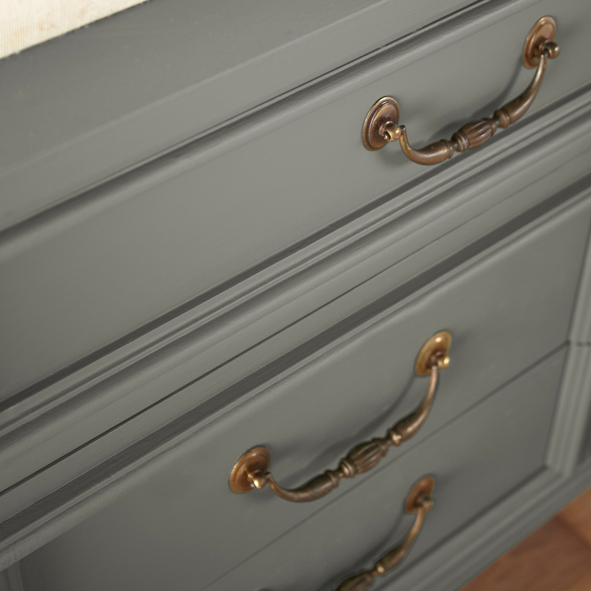 A deep sage with a soft gray undertone door and cabinet paint named estate shown painted on cabinet