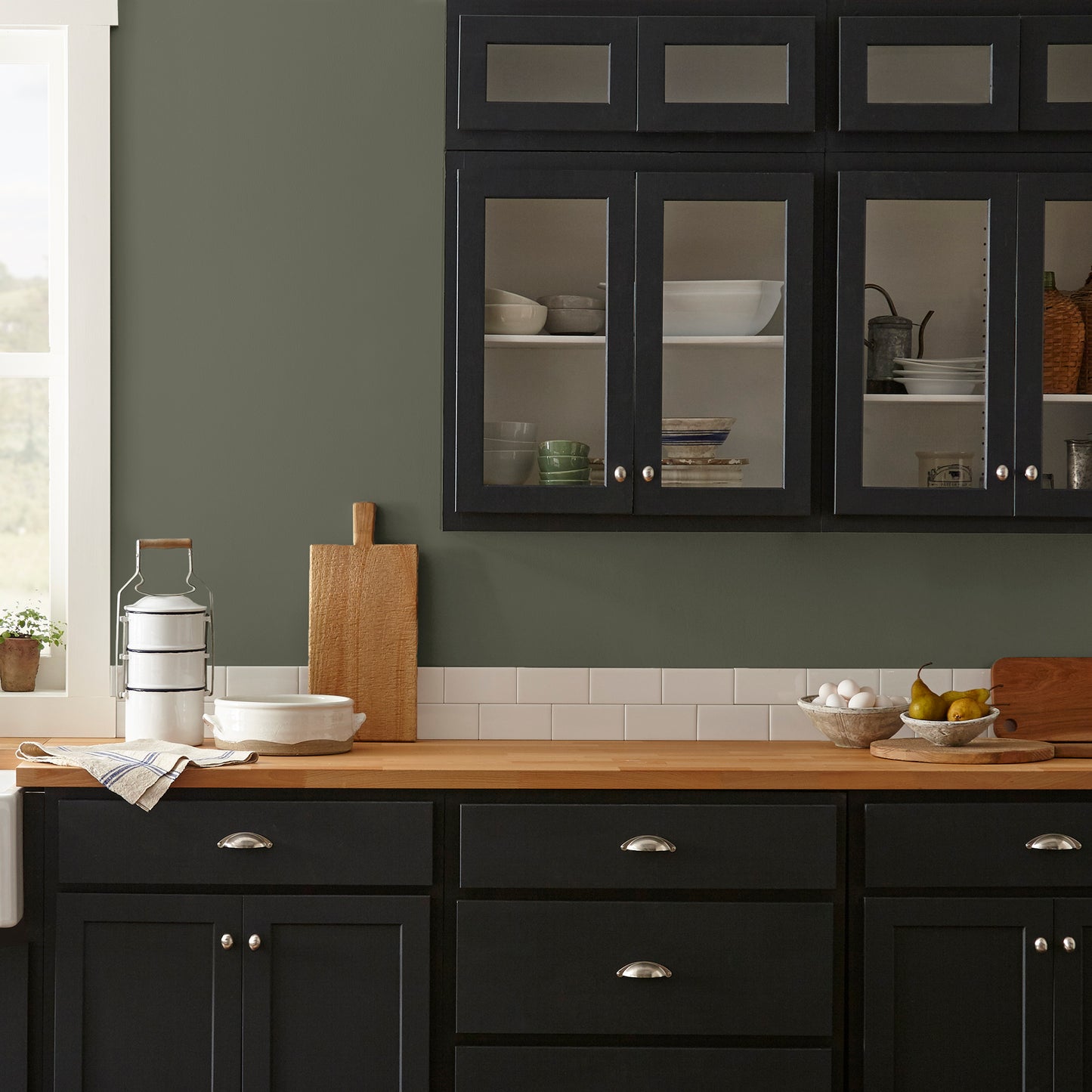 deep olive green interior paint named Step Stool Green shown painted on kitchen wall