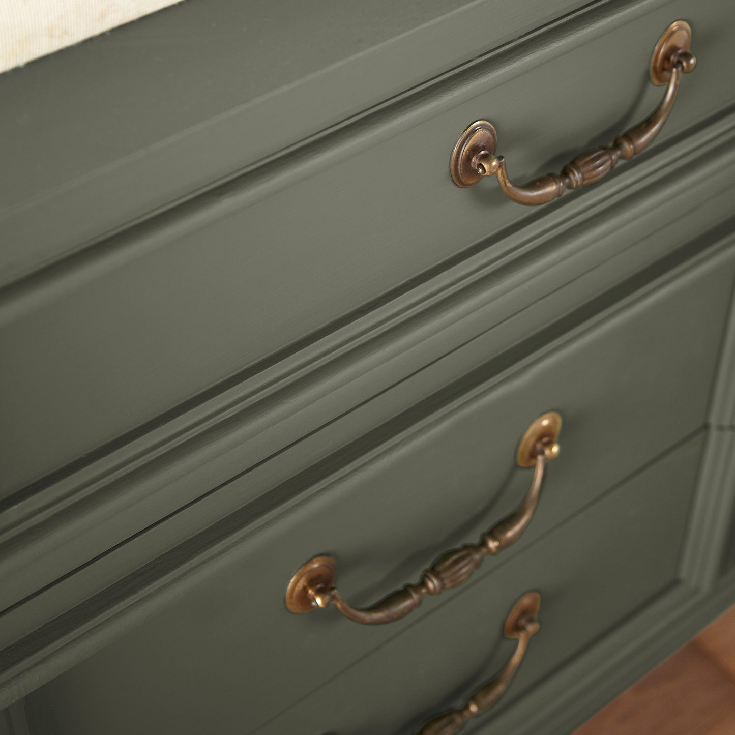 A lively, deep olive door and cabinet paint named step stool green shown painted on cabinet