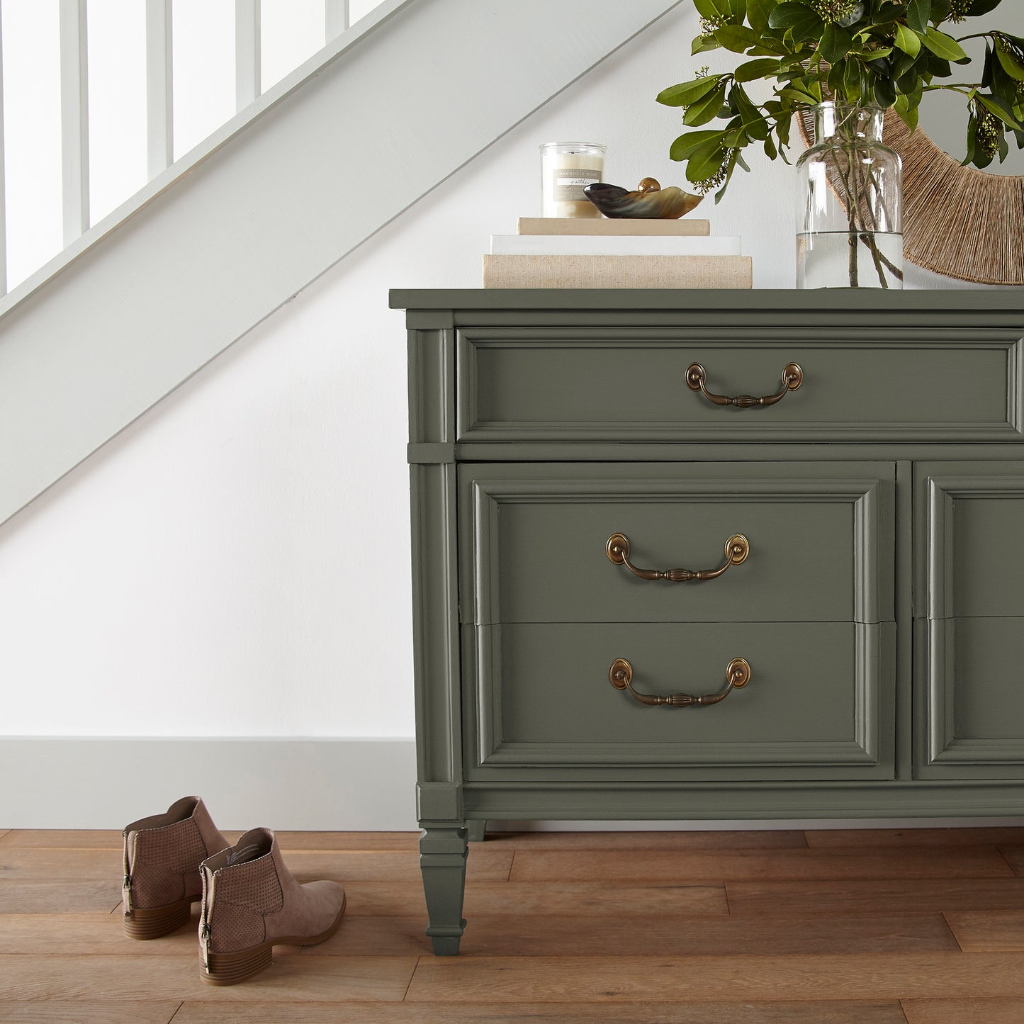 A lively, deep olive door and cabinet paint named step stool green shown painted on entryway cabinet