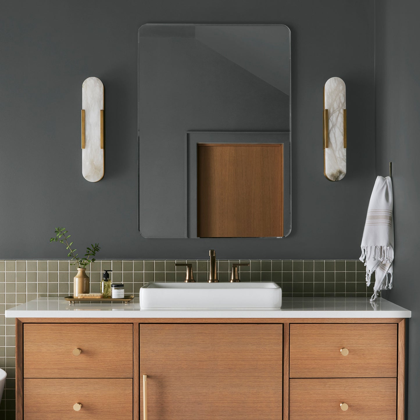 moody navy infused with deep green interior paint named cottage grove shown painted on bathroom wall