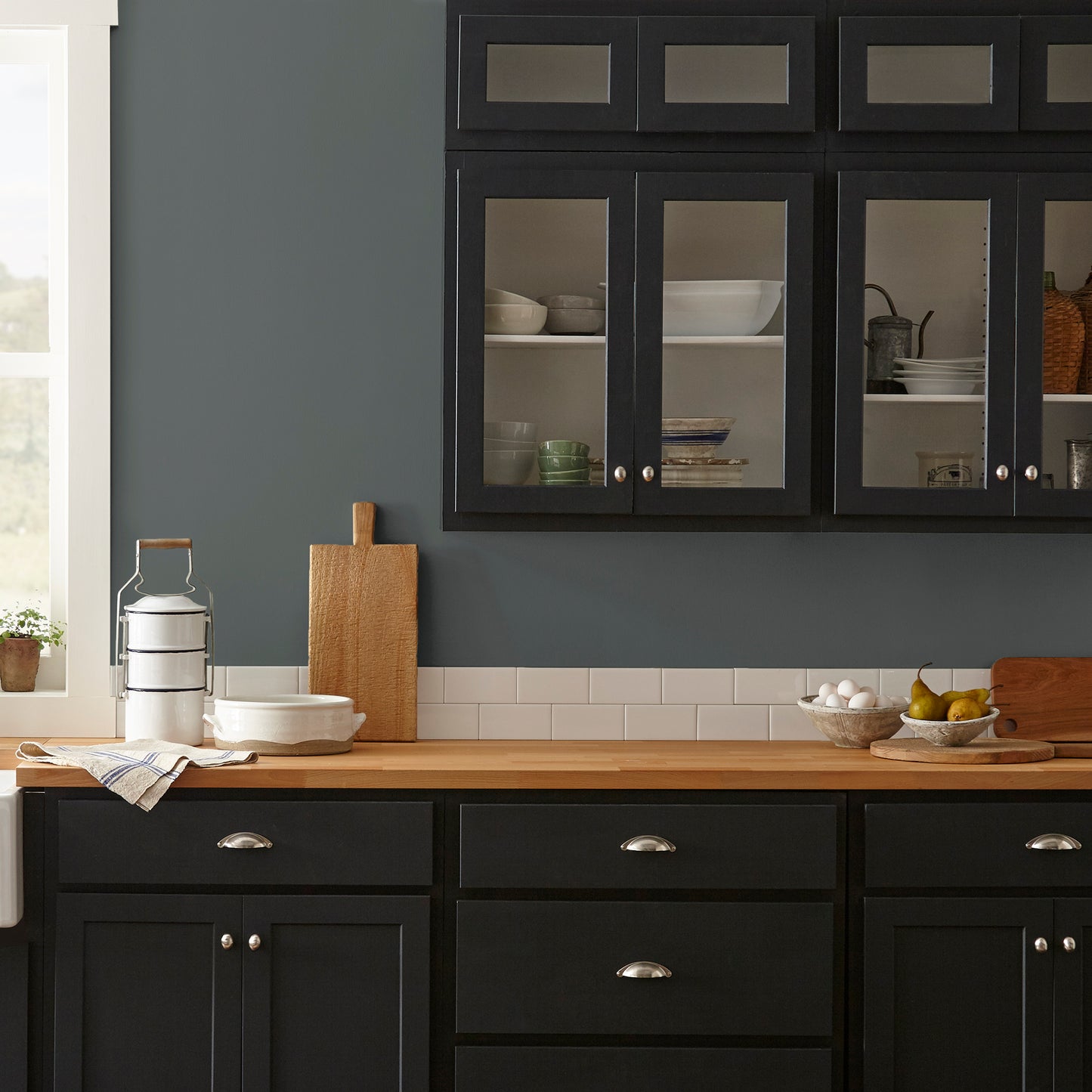 moody navy infused with deep green interior paint named cottage grove shown painted on kitchen wall