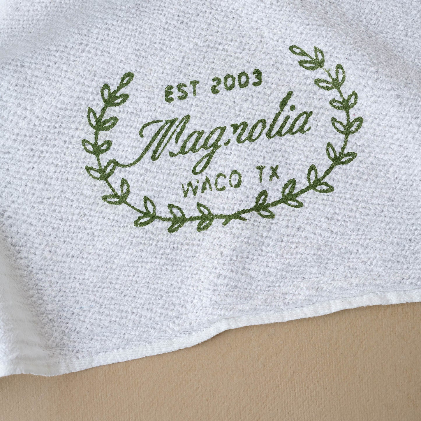 Magnolia Sage Laurel Wreath Tea Towel close up of design