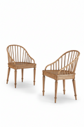Two wooden chairs with curved backrests on a white background