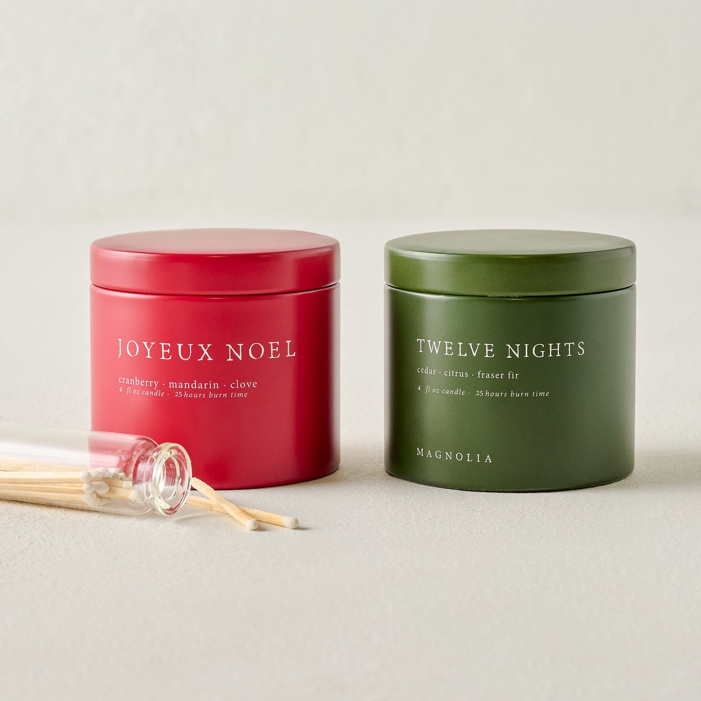 Magnolia Joyeux Noel and Twelve Nights Candle Tin Bundle shown with matches