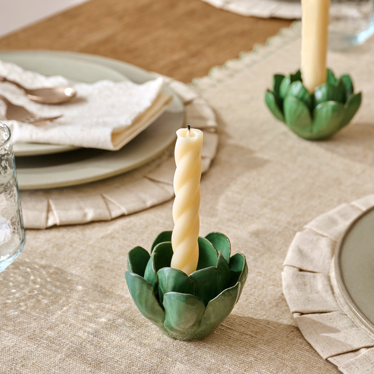 Celia Floral Taper Holder shown on table with taper candle