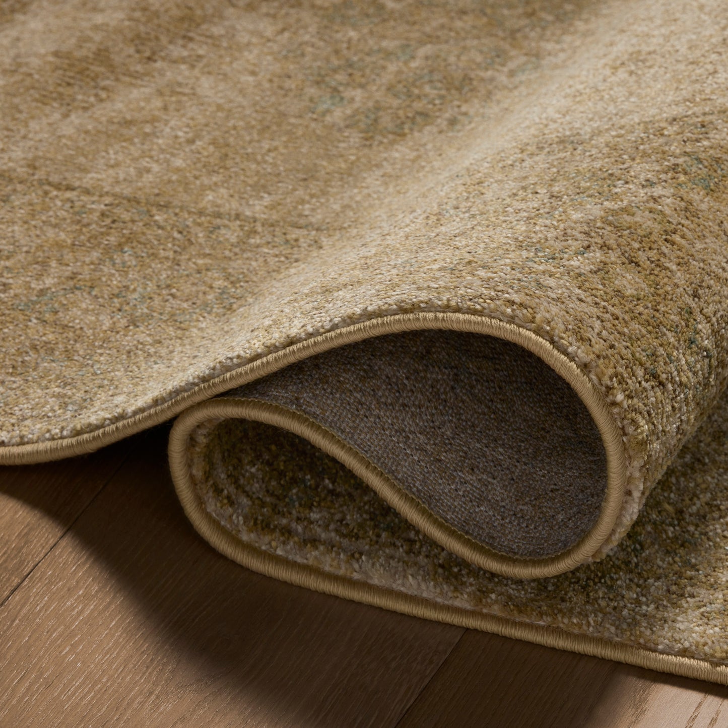 Mona Antique Spa Rug close up of rolled rug
