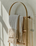 Antique Brass Carmen Wall Ladder close up view with Antique White Essential Tassel Throw