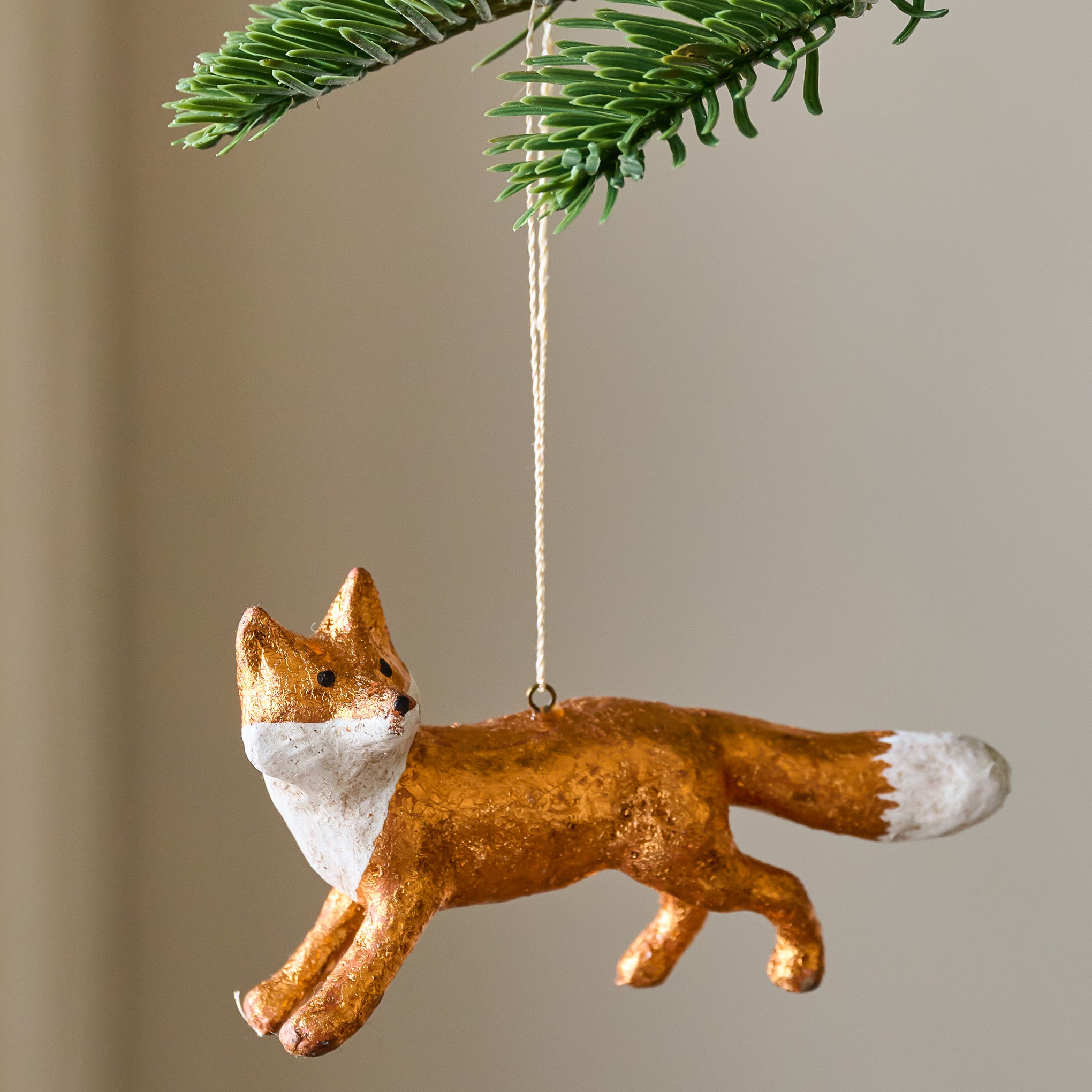 Hand Crafted Fox Ornament shown hung from tree