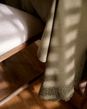 Olive Green Scalloped Eyelet Tablecloth close up next to chair