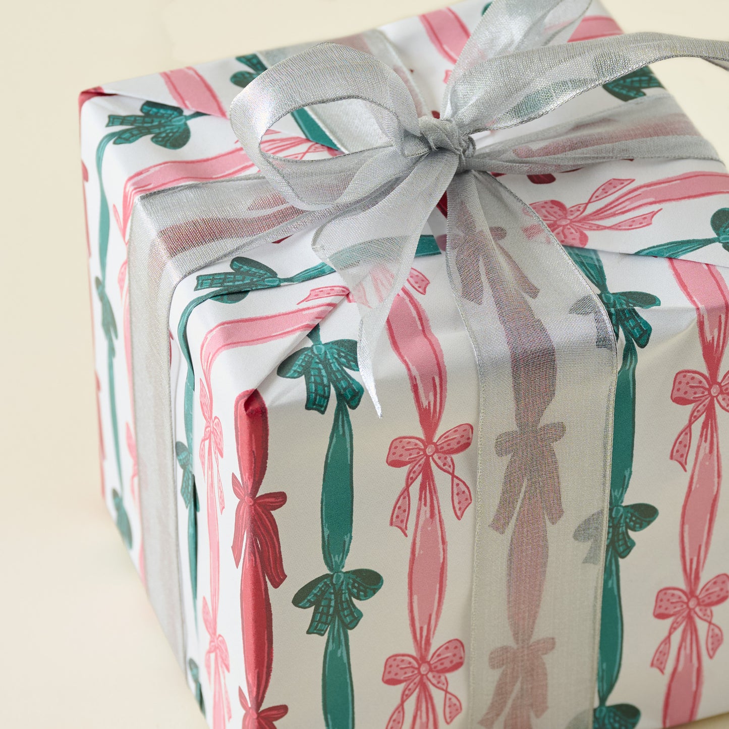 Christmas Ribbons and Bows Wrapping Paper Roll shown on gift