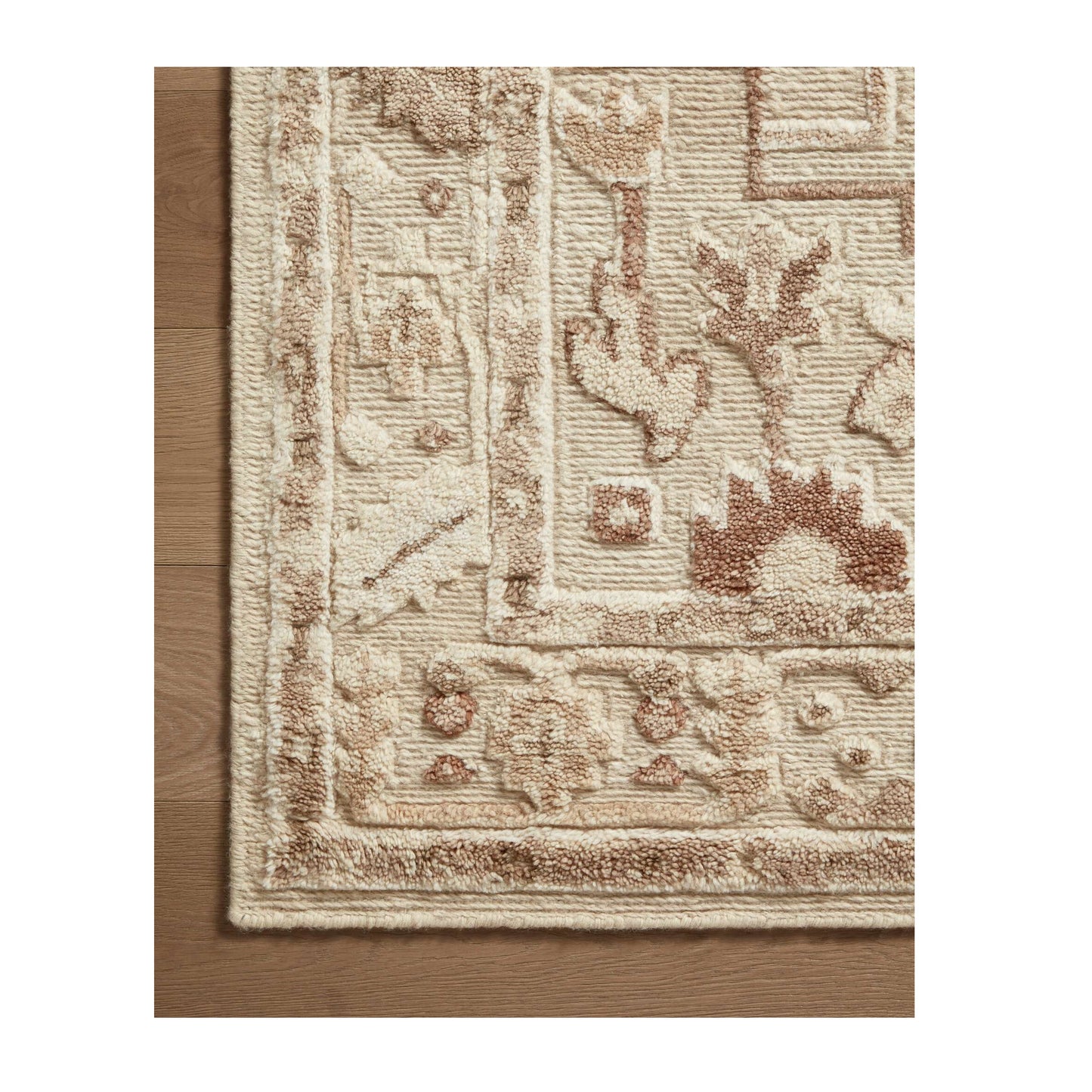 Ingrid Ivory Earth Rug close up of corner on wood floor