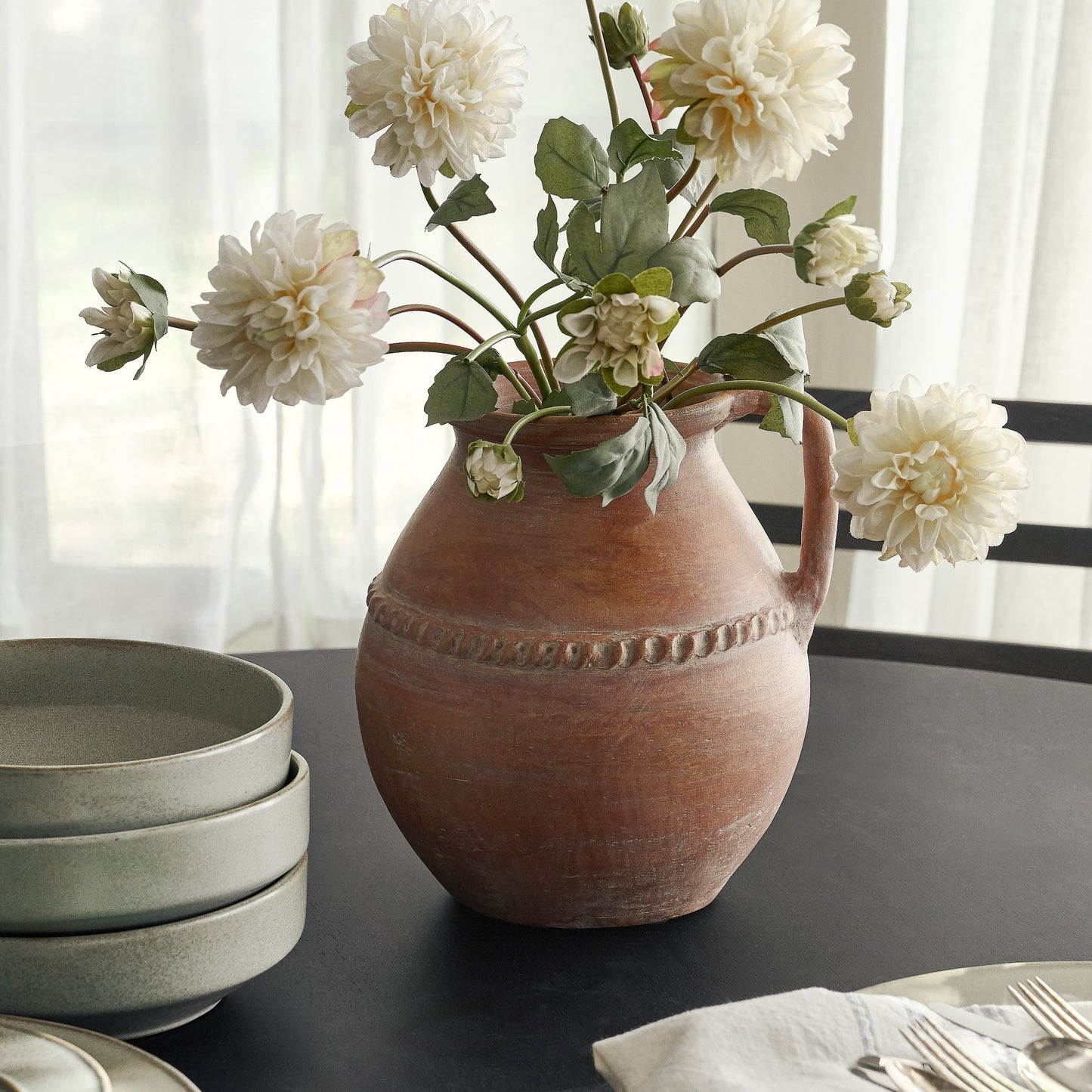 Camila Rust Terracotta Vase with white faux dahlia stem set on dining table