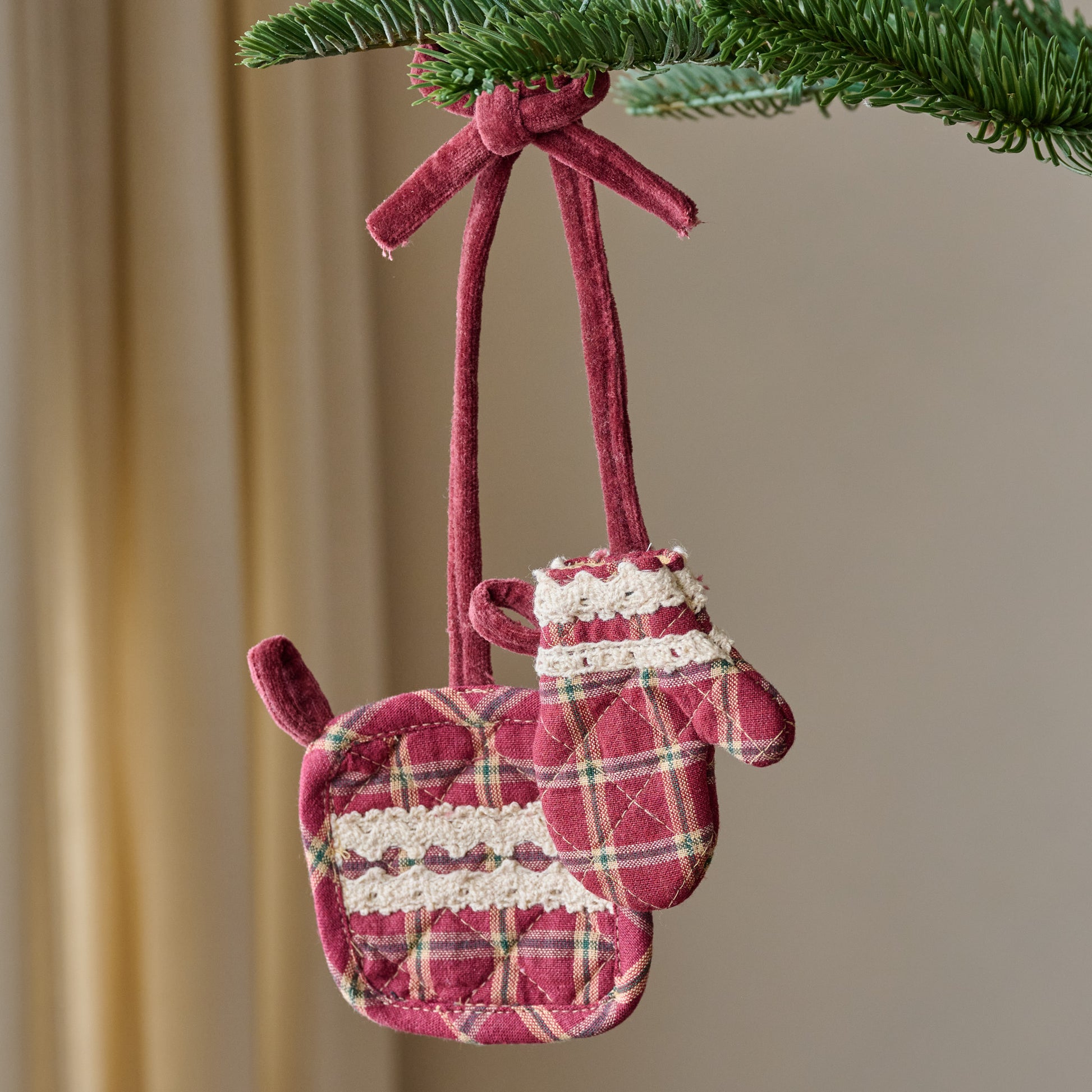 Magnolia Red Plaid Oven Mit + Pot Holder Ornament shown hung from branch