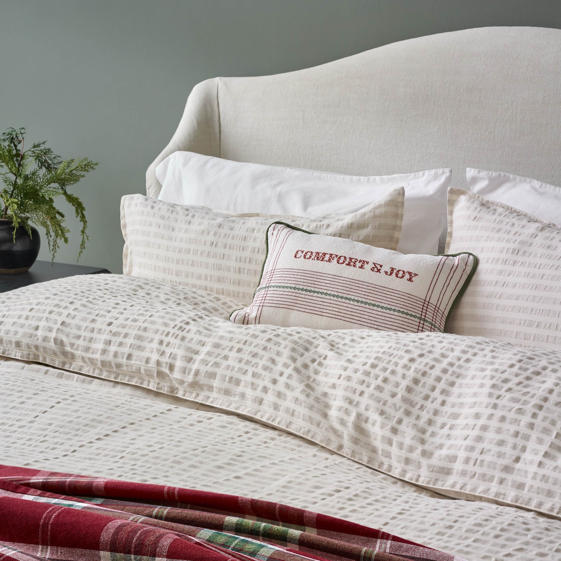 Antique White + Oatmeal Stripe Linen Cotton Pillow Sham on a bed