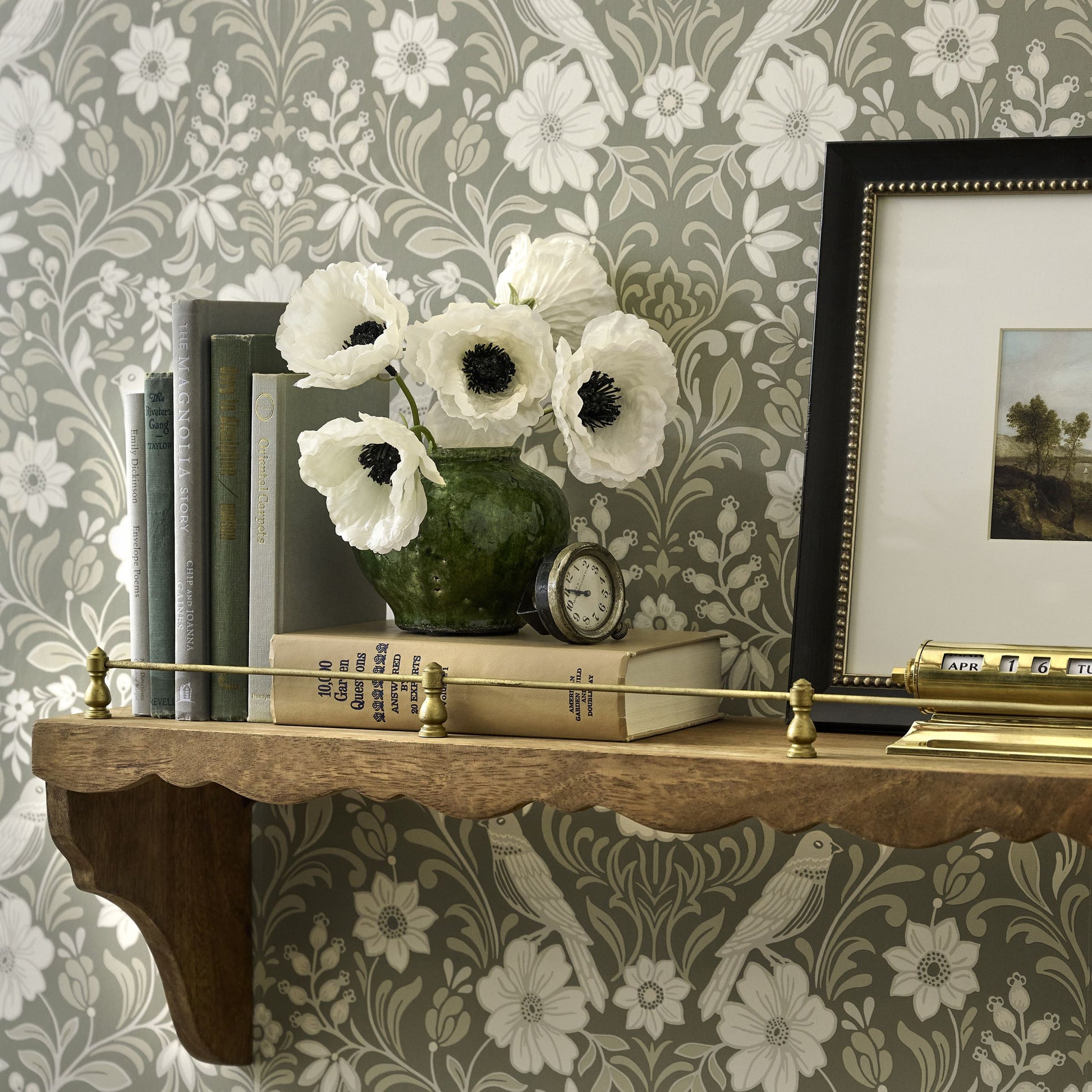White Anemone Bouquet in green ceramic bud base on wall shelf
