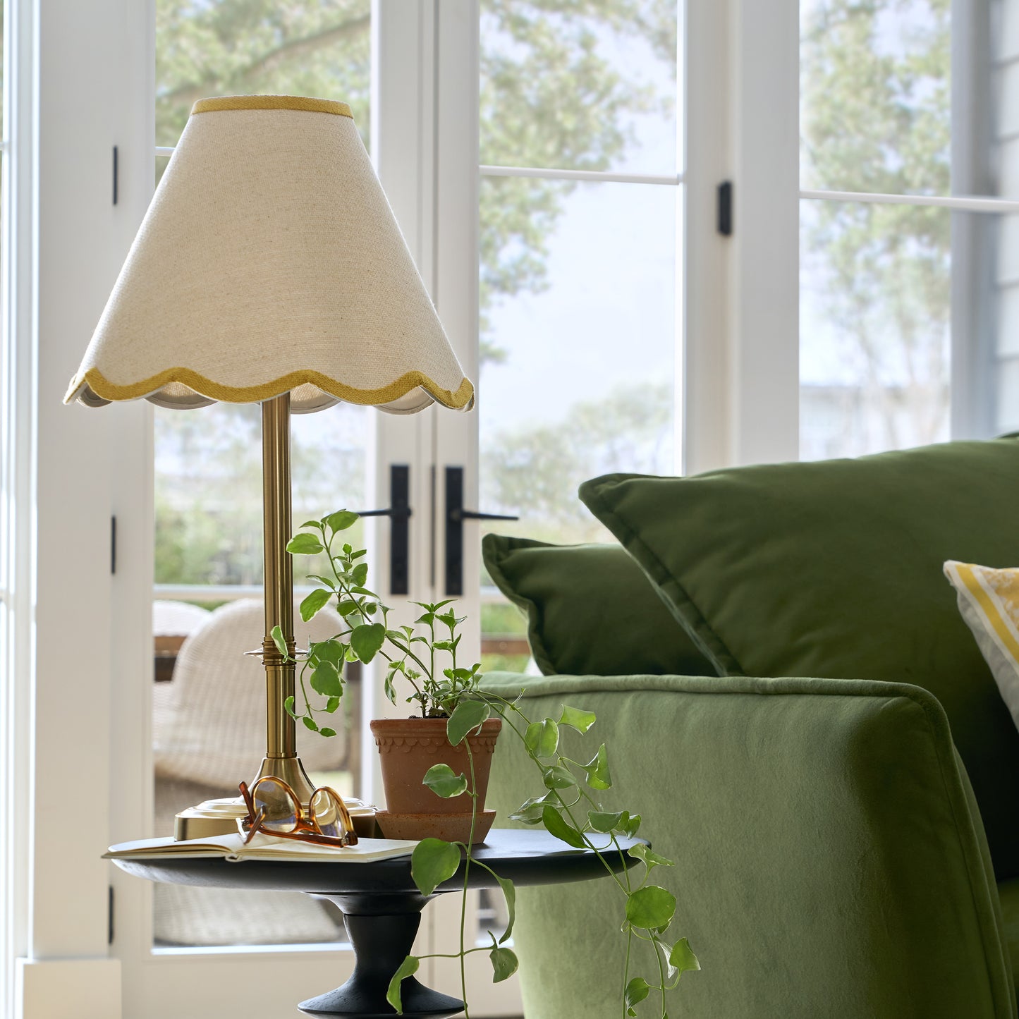 Carmen Brass Table Lamp with yellow wavy linen shade shown on accent table in linen room