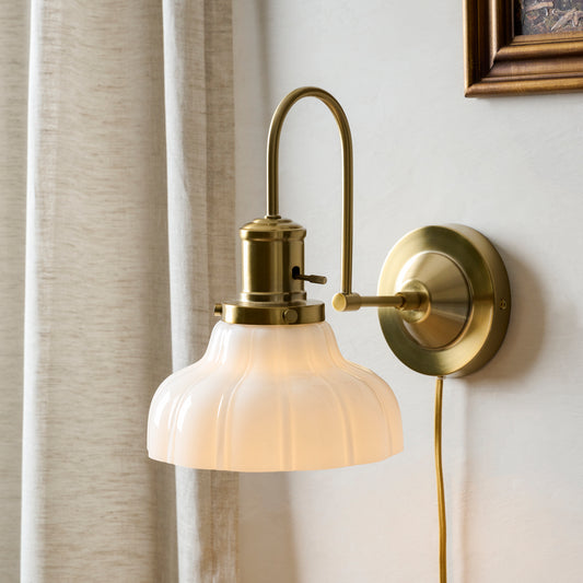 Polly Milk Glass Plug-in Sconce shown on wall