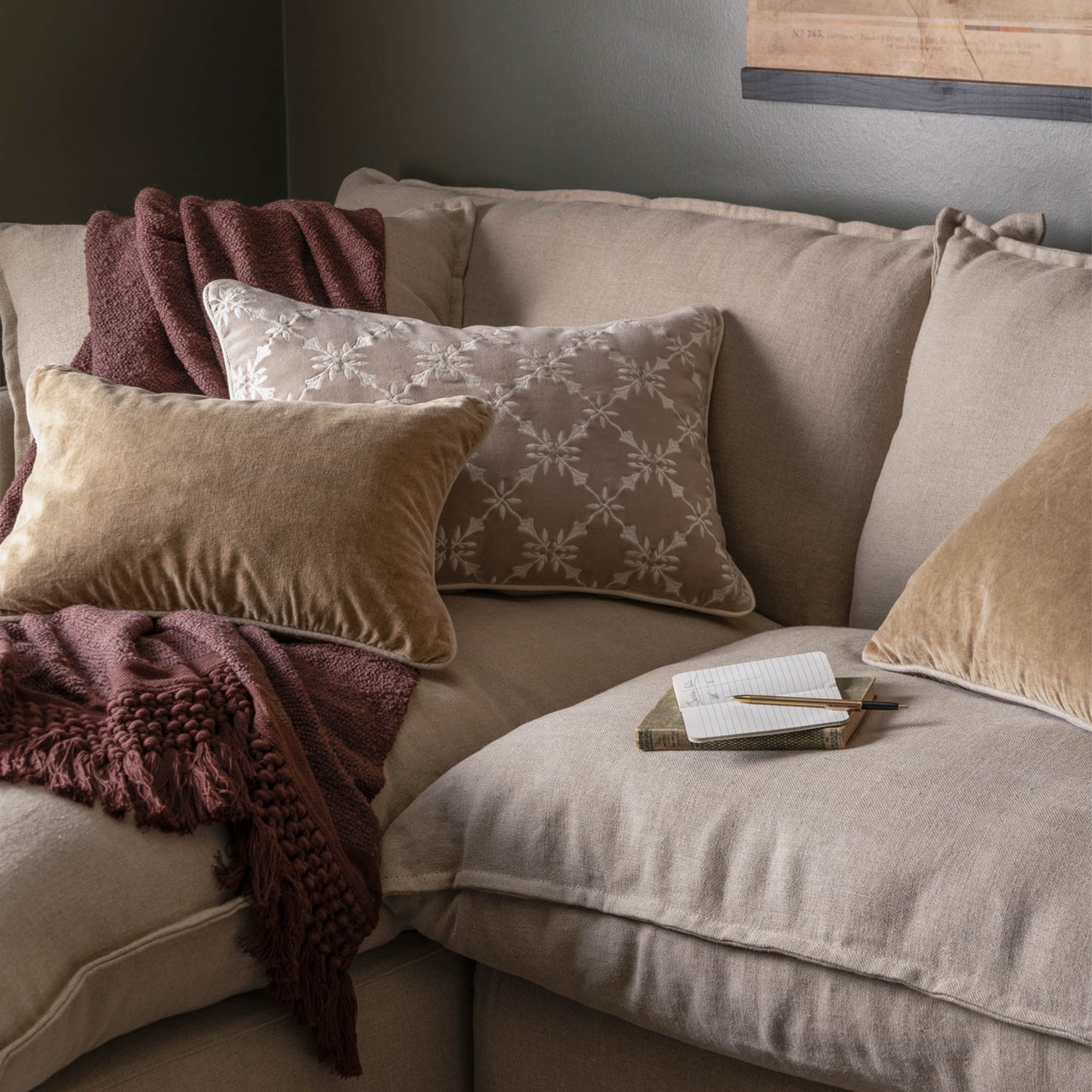 Aurora Embroidered Velvet Lumbar Pillow on a couch