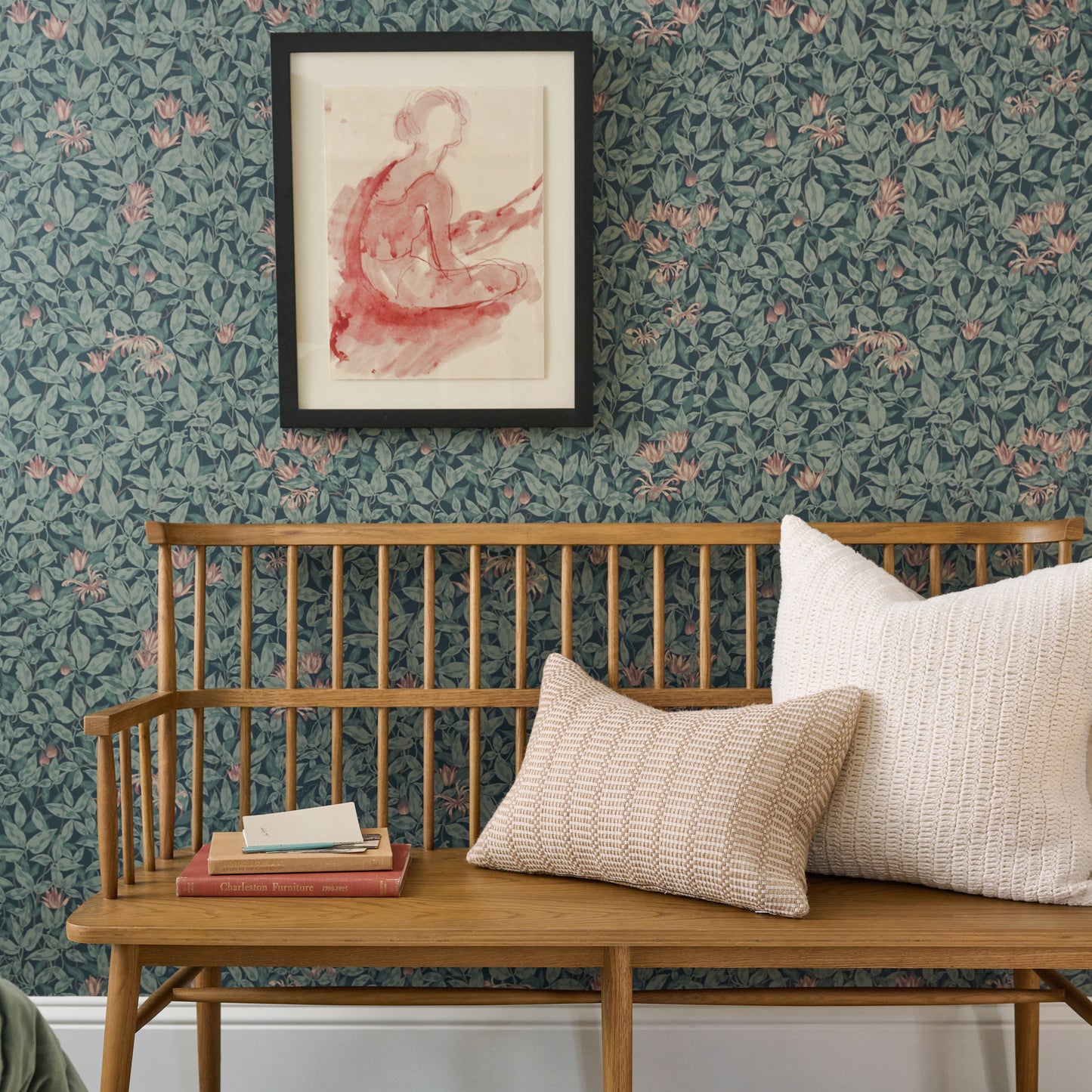 framed wall art called Dancer on floral wallpaper above a bench