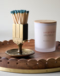 Antique Brass Vintage-Inspired Etched Match Holder next to Joyeux Noel candle on wooden tray