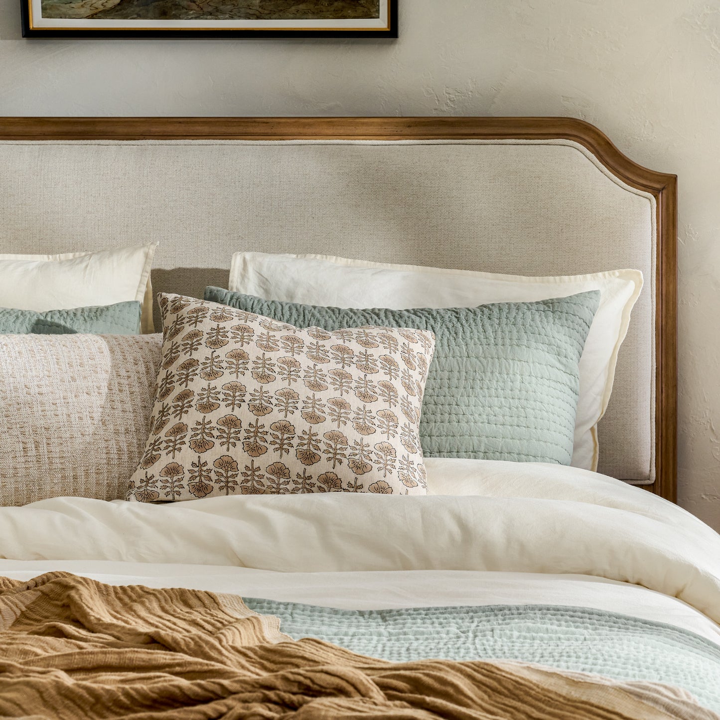 Flora Natural Printed Pillow on a bed