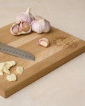 Magnolia Seal Cutting Board with chopped garlic on top