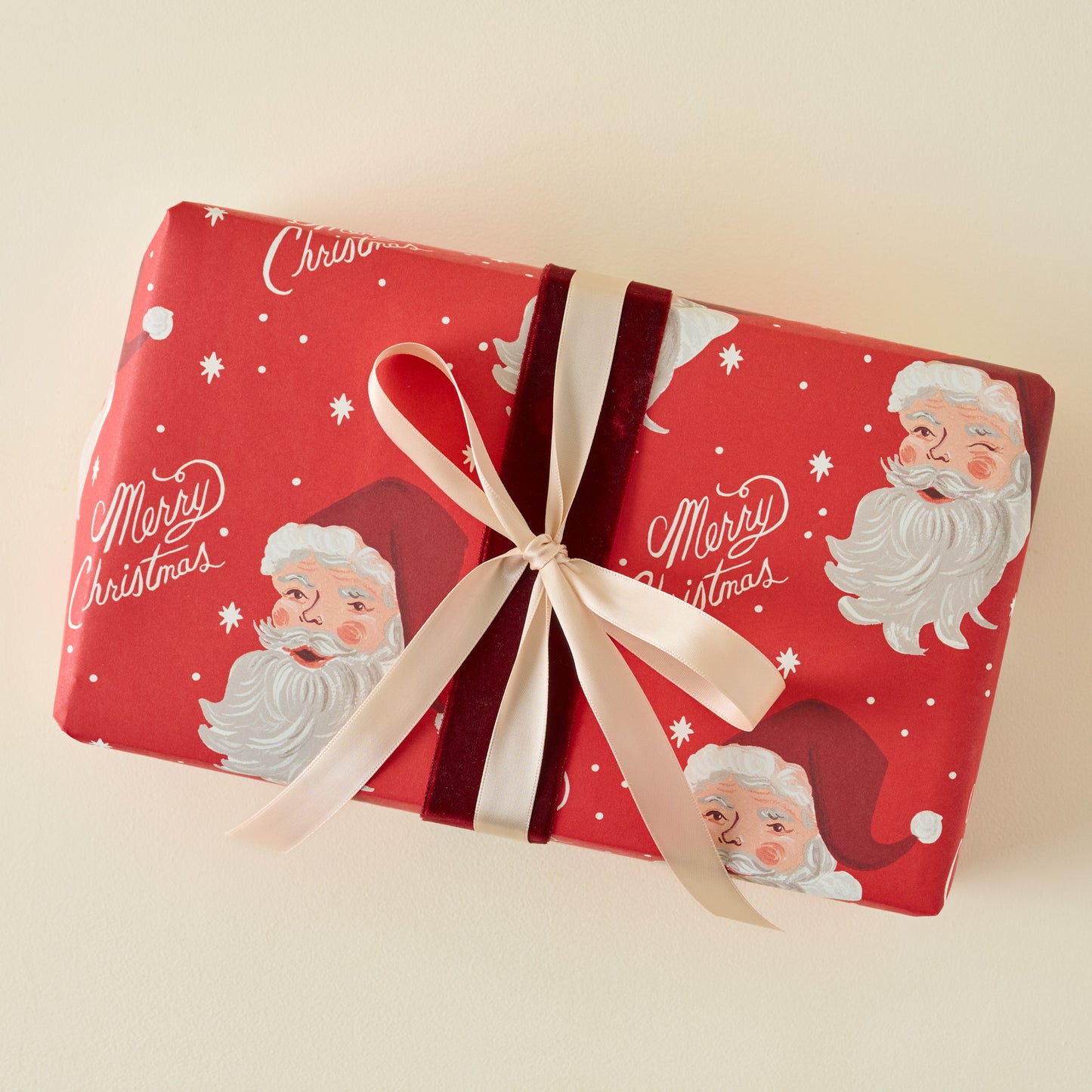 Red Santa Three Sheet Wrapping Roll shown on gift