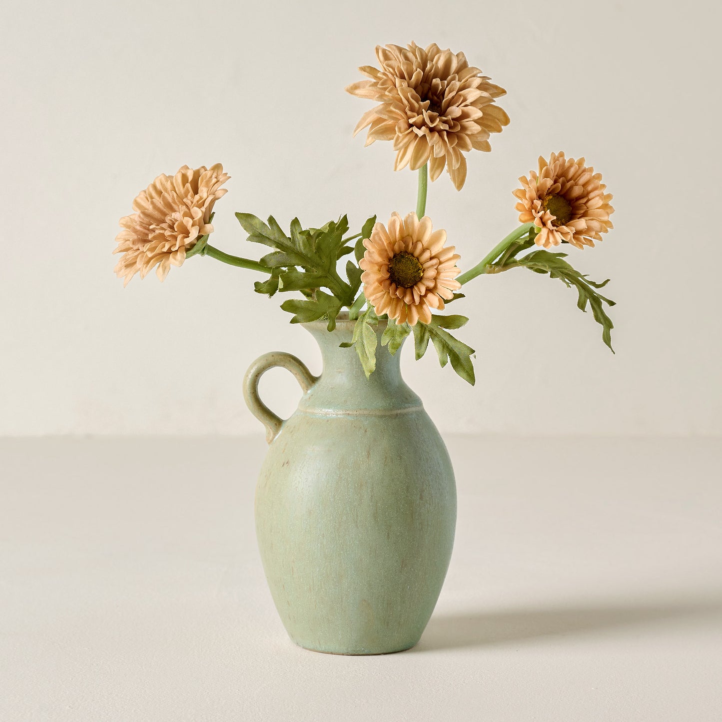 Small Rustic Green Vase holding flowers