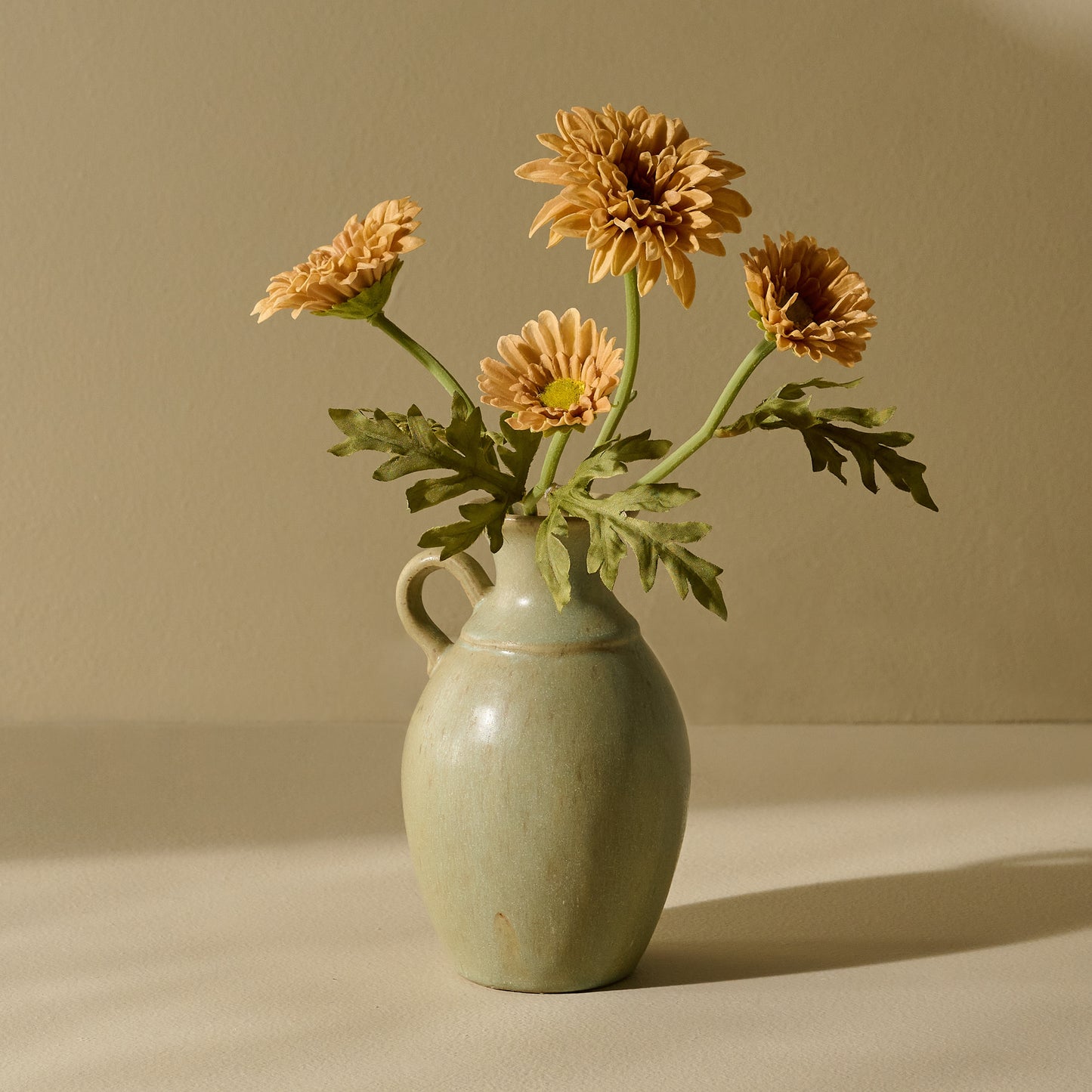 Small Rustic Green Vase holding flowers