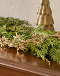 Stella Glimmer Garland shown with greenery