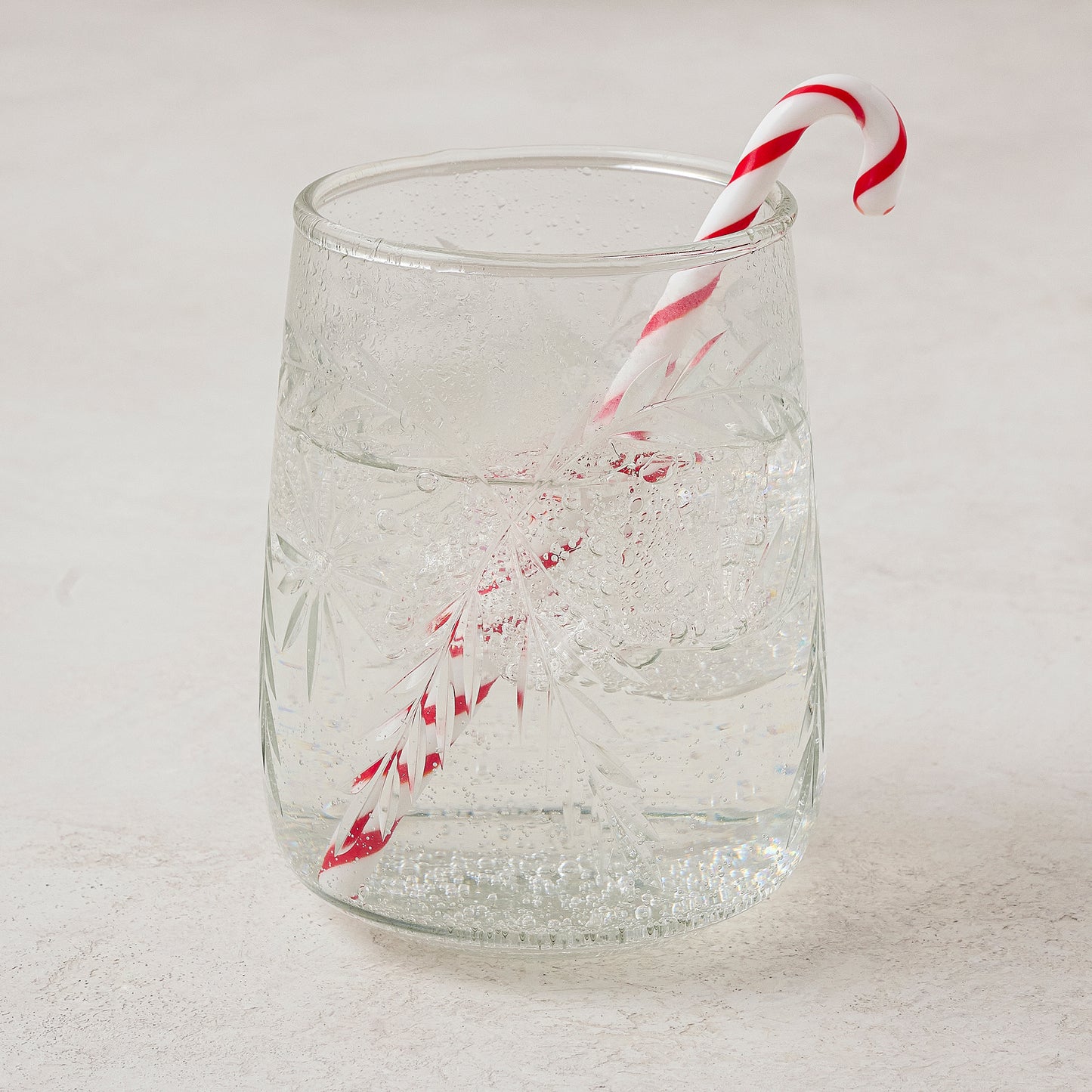 Candy Cane Cocktail Stirrer shown in glass with drink