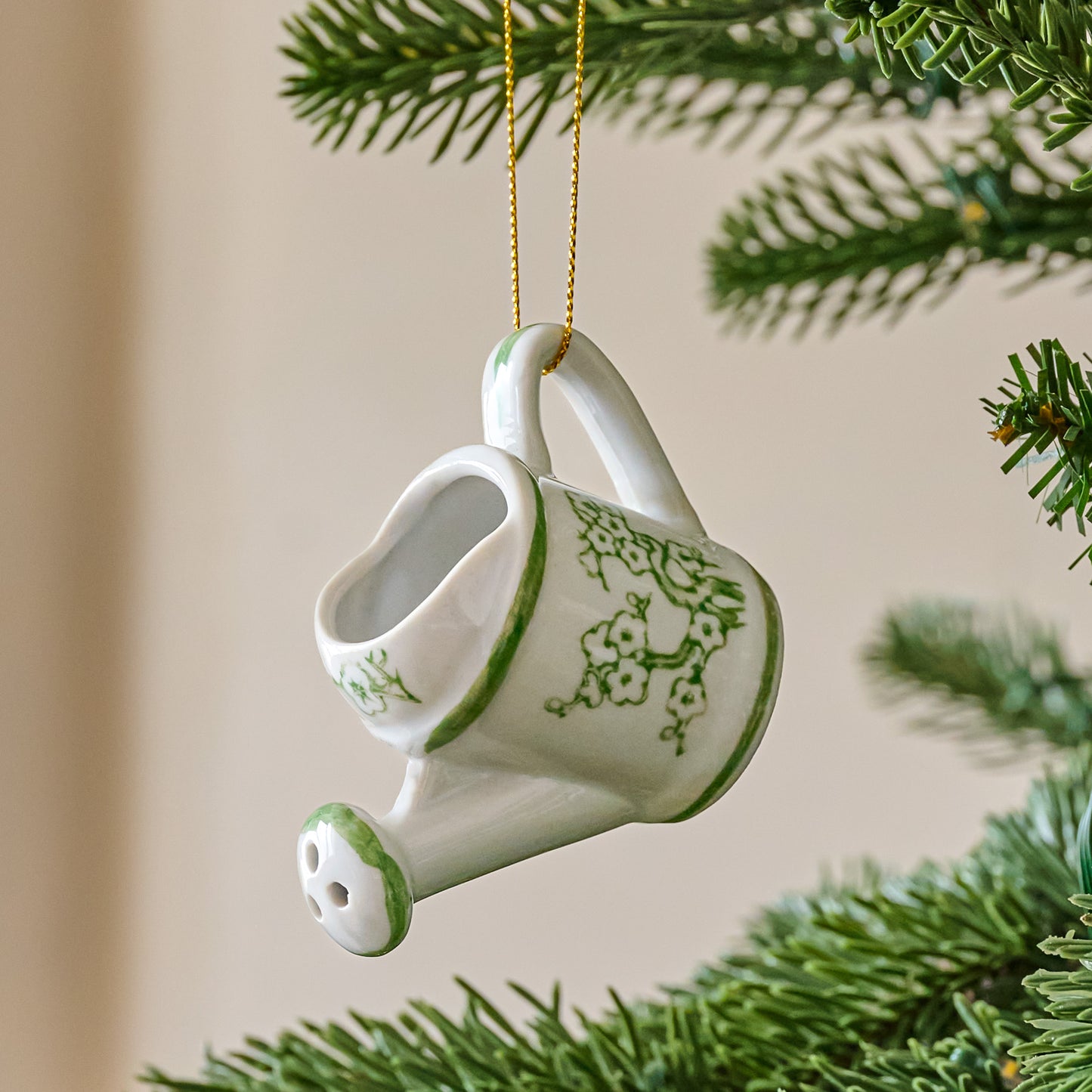 Ceramic Watering Can Ornament shown on tree