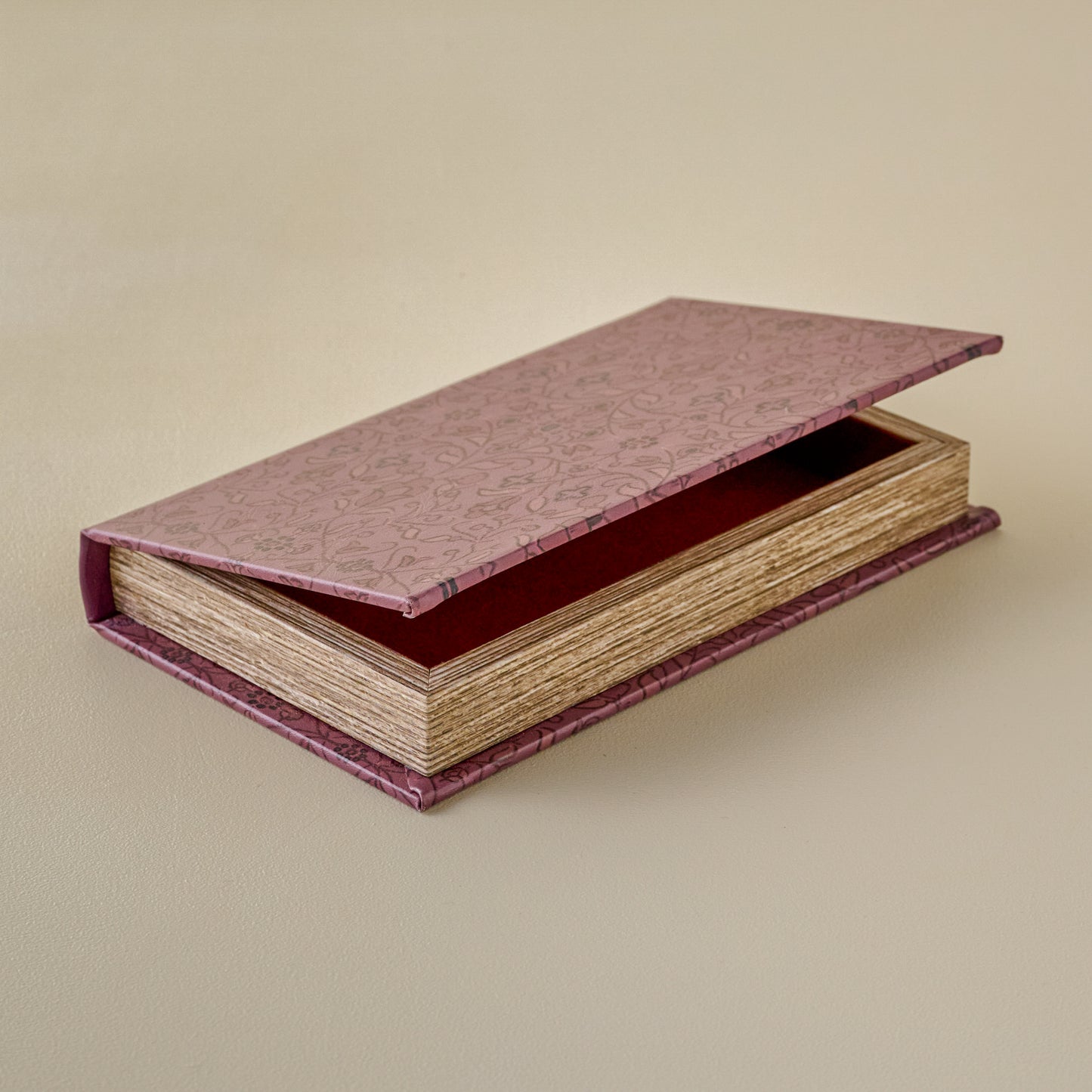 Vintage-Inspired Handcrafted Book Box with a textured pinkish-red lid on a beige background