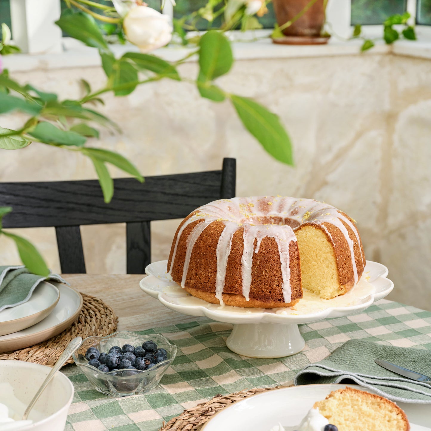 Cream Scalloped Cake Stand on a table with a lemon bundt cake on top