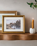 Vintage Steeple View in front of another landscape art and next to a taper holder