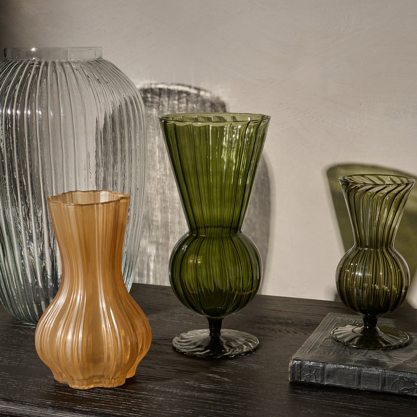 Small and Large Fluted Green Glass Vases shown with other vases