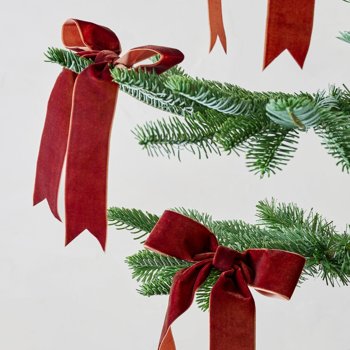 Burgundy Velvet Bow Ornament Clip, Set of 8 shown on tree