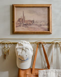 Seaside Village styled on the wall above brass wall hooks