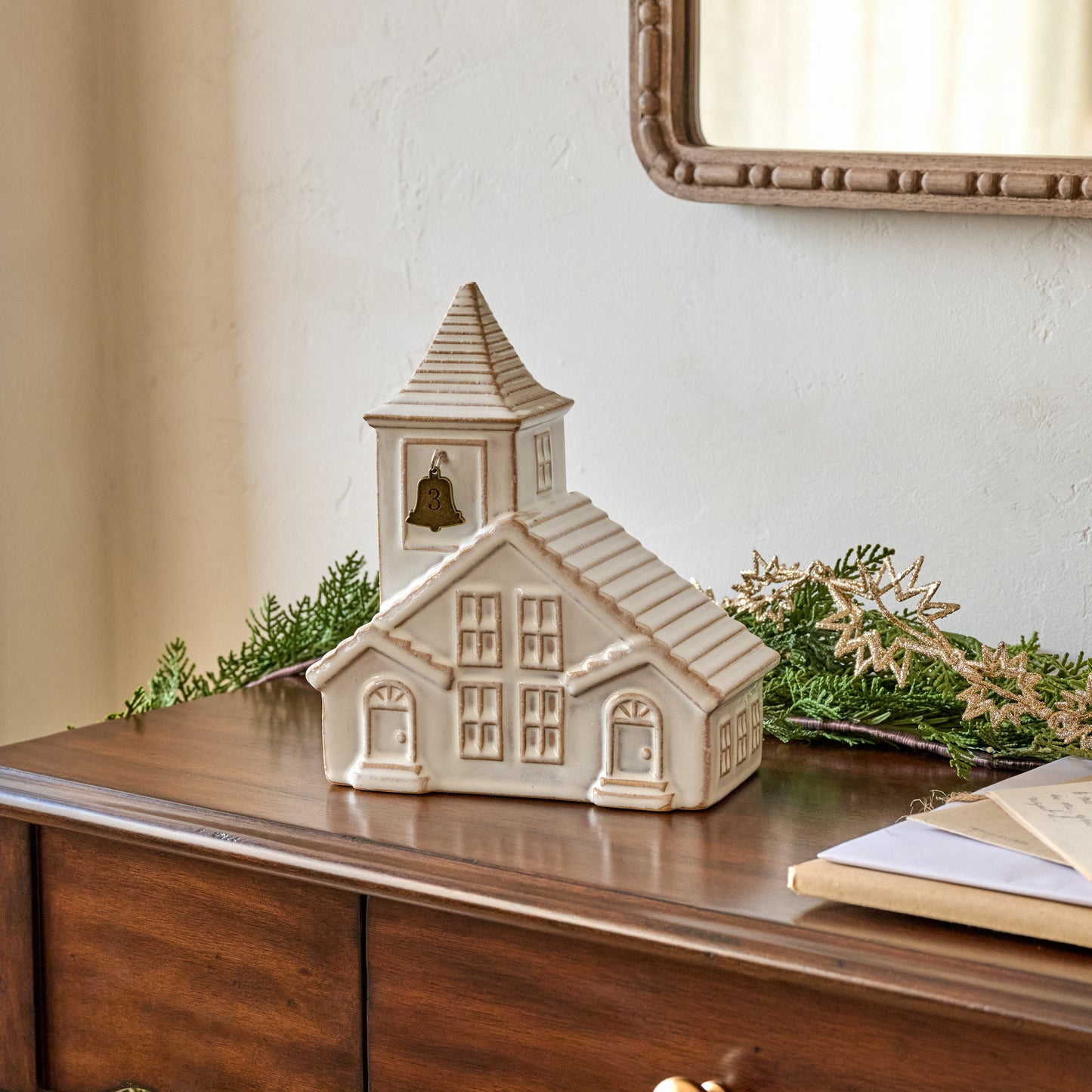 Ceramic Church Bell Countdown to Christmas shown styled on console table