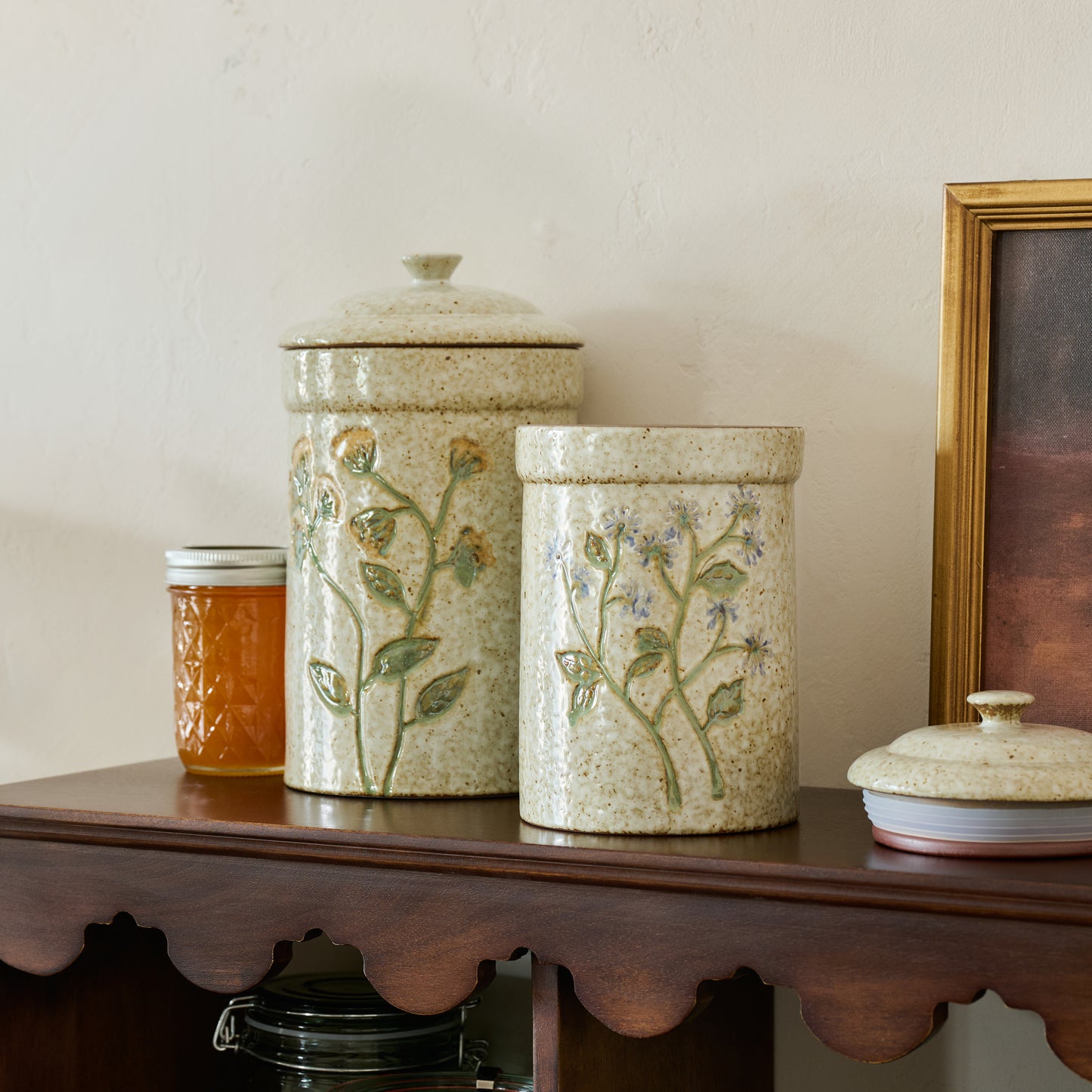Golden Wildflower Canister shown with blue canister on shelf